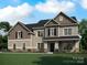 Charming two-story home featuring a well-manicured lawn and a welcoming front porch and multi-tone color scheme at 1008 Marquis Hills Dr # Mas0106, Fort Mill, SC 29715