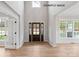 Bright foyer with a tall ceiling, hardwood floors, a stylish front door, and a view to the outside at 1008 Marquis Hills Dr # Mas0106, Fort Mill, SC 29715