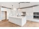 Modern kitchen with white cabinets, a large island, stainless steel appliances, and hardwood floors at 1008 Marquis Hills Dr # Mas0106, Fort Mill, SC 29715