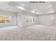Expansive living room features large windows and plush carpeting at 1008 Marquis Hills Dr # Mas0106, Fort Mill, SC 29715