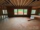Unfinished living room featuring framed windows offering ample natural light and exposed ceiling beams at 1008 Marquis Hills Dr # Mas0106, Fort Mill, SC 29715