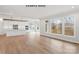 Spacious living space featuring an open kitchen, a dining area with large windows, and hardwood floors at 1008 Marquis Hills Dr # Mas0106, Fort Mill, SC 29715