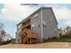 Gray siding on a home with a large deck and stairs leading to the backyard, surrounded by trees at 1008 Marquis Hills Dr # Mas0106, Fort Mill, SC 29715