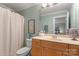 Bathroom featuring a vanity with mirror, shower with patterned curtain, and neutral decor at 1016 Antioch Woods Ln # 36, Weddington, NC 28104