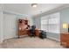 Bedroom with a built-in wooden desk, carpet flooring, and a large window for ample light at 1016 Antioch Woods Ln # 36, Weddington, NC 28104