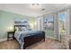 Cozy bedroom with soothing blue accents, carpet flooring, two windows, and nautical themed decorations at 1016 Antioch Woods Ln # 36, Weddington, NC 28104