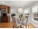 Bright breakfast nook featuring a round table, decorative chairs, and multiple windows at 1016 Antioch Woods Ln # 36, Weddington, NC 28104