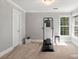 Bright exercise room featuring carpet, neutral paint, gym equipment and natural light from windows at 1016 Antioch Woods Ln # 36, Weddington, NC 28104