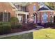 Elegant brick home featuring arched entryway, symmetrical windows, and manicured shrubbery at 1016 Antioch Woods Ln # 36, Weddington, NC 28104