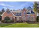 Stately brick home featuring a manicured lawn and a classic arched entryway at 1016 Antioch Woods Ln # 36, Weddington, NC 28104