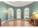 Beautiful living room featuring a hardwood floor, arched windows and unique colors at 1016 Antioch Woods Ln # 36, Weddington, NC 28104