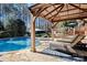 Relaxing poolside with a covered gazebo and lounge chairs, surrounded by greenery at 1016 Antioch Woods Ln # 36, Weddington, NC 28104