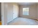 Small bedroom with a closet and a window at 10386 Turnplow Dr, Davidson, NC 28036