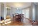 Bright dining room with wood floors and access to a deck at 10386 Turnplow Dr, Davidson, NC 28036