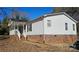 White single story home with covered porch and brick foundation at 10386 Turnplow Dr, Davidson, NC 28036