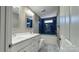 Modern bathroom with double vanity, blue tile, and a bathtub at 1057 12Th Avenue Nw Dr, Hickory, NC 28601