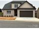 Two-story house with beige brick, dark brown garage door and landscaping at 1057 12Th Avenue Nw Dr, Hickory, NC 28601