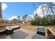 Spacious backyard with a large deck featuring comfortable outdoor seating and a well-maintained lawn at 11400 Five Cedars Rd, Charlotte, NC 28226