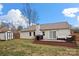 Backyard featuring a deck, patio furniture, and a well-maintained lawn, perfect for outdoor entertaining at 11400 Five Cedars Rd, Charlotte, NC 28226