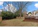 Large backyard featuring a mix of grass and bare patches, a shed, and a wooden fence at 11400 Five Cedars Rd, Charlotte, NC 28226