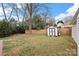 Large grassy backyard featuring a shed and a wooden privacy fence for outdoor enjoyment at 11400 Five Cedars Rd, Charlotte, NC 28226