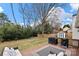 Expansive backyard featuring a deck with outdoor seating, lush greenery, and a wooden fence at 11400 Five Cedars Rd, Charlotte, NC 28226