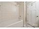 Bright bathroom featuring a shower-tub combination with ceramic tile and a stylish patterned floor at 11400 Five Cedars Rd, Charlotte, NC 28226