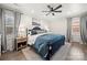 Comfortable bedroom featuring a ceiling fan, plush bedding, and warm natural light at 11400 Five Cedars Rd, Charlotte, NC 28226