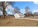 Inviting one-story home featuring bright white siding, a manicured lawn and a lovely tree lined street at 11400 Five Cedars Rd, Charlotte, NC 28226