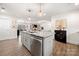 Open concept kitchen with stainless steel appliances, marble countertops, and modern lighting at 11400 Five Cedars Rd, Charlotte, NC 28226