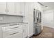 Bright kitchen with white cabinets, stainless steel appliances, and light countertops at 11400 Five Cedars Rd, Charlotte, NC 28226