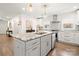 Bright kitchen features a marble island, stainless appliances, and modern lighting at 11400 Five Cedars Rd, Charlotte, NC 28226