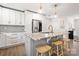 Kitchen features a marble island, stainless appliances, and modern lighting fixtures at 11400 Five Cedars Rd, Charlotte, NC 28226