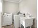 Laundry room with washer, dryer, wash sink and storage at 11400 Five Cedars Rd, Charlotte, NC 28226