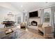 Bright living room featuring a brick fireplace and comfortable seating, transitioning to the dining area at 11400 Five Cedars Rd, Charlotte, NC 28226