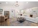 Elegant living room with hardwood floors, a plush white sectional, and modern décor at 11400 Five Cedars Rd, Charlotte, NC 28226