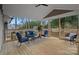 Relaxing covered back porch with seating area at 1213 Hartford Ave, Charlotte, NC 28209