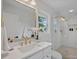 Modern bathroom with a frameless shower, marble tile and gold fixtures at 1213 Hartford Ave, Charlotte, NC 28209