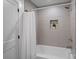 Clean bathroom with a shower/tub combo and light gray brick tile at 1213 Hartford Ave, Charlotte, NC 28209