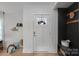 Bright entryway with white door and dark accent wall at 1213 Hartford Ave, Charlotte, NC 28209