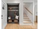 Modern entryway with built-in bench, storage, and stairs at 1213 Hartford Ave, Charlotte, NC 28209