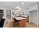 Bright kitchen with an island and white cabinets at 1213 Hartford Ave, Charlotte, NC 28209