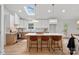 Modern kitchen with island, skylight, and light wood cabinets at 1213 Hartford Ave, Charlotte, NC 28209