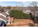 An aerial view displays a well-maintained lawn, fenced yard, and a home with a deck at 1221 Cochrane Woods Ln, Matthews, NC 28105