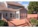 Back porch featuring a wood deck with access to the home through sliding glass doors at 1221 Cochrane Woods Ln, Matthews, NC 28105