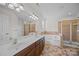 Bright bathroom featuring a double vanity, soaking tub, and a separate glass-enclosed shower at 1221 Cochrane Woods Ln, Matthews, NC 28105