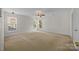 Bedroom featuring neutral carpet, three windows and ceiling fan at 1221 Cochrane Woods Ln, Matthews, NC 28105