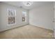 Bright bedroom featuring natural light from large windows, creating a warm and inviting space at 1221 Cochrane Woods Ln, Matthews, NC 28105