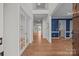 Bright foyer with hardwood floors, elegant french doors, and a view of the home's open layout at 1221 Cochrane Woods Ln, Matthews, NC 28105