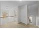 Hallway view with white railings, neutral carpeting, and natural light at 1221 Cochrane Woods Ln, Matthews, NC 28105